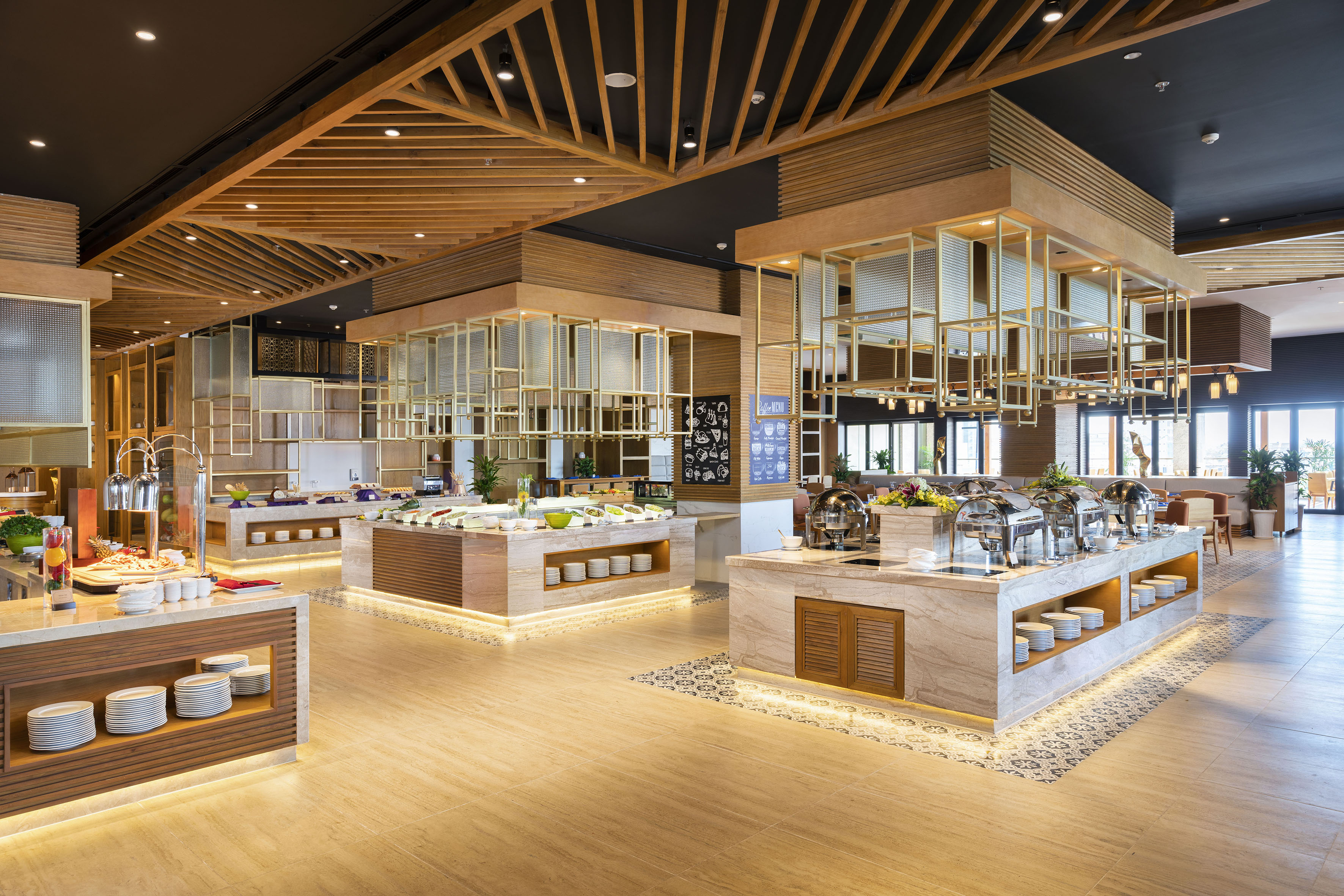 Modern buffet restaurant with food stations and elegant wood interior design.
