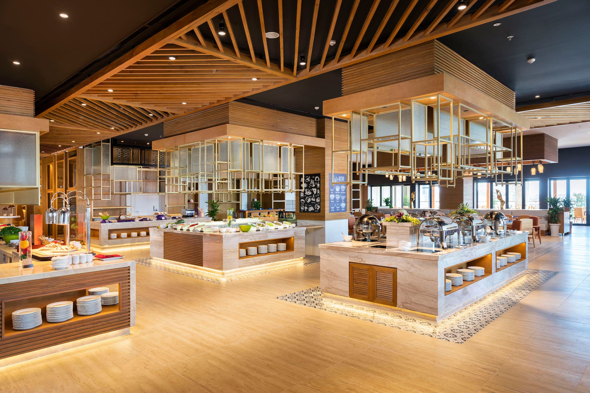 Modern buffet restaurant with food stations and elegant wood interior design.