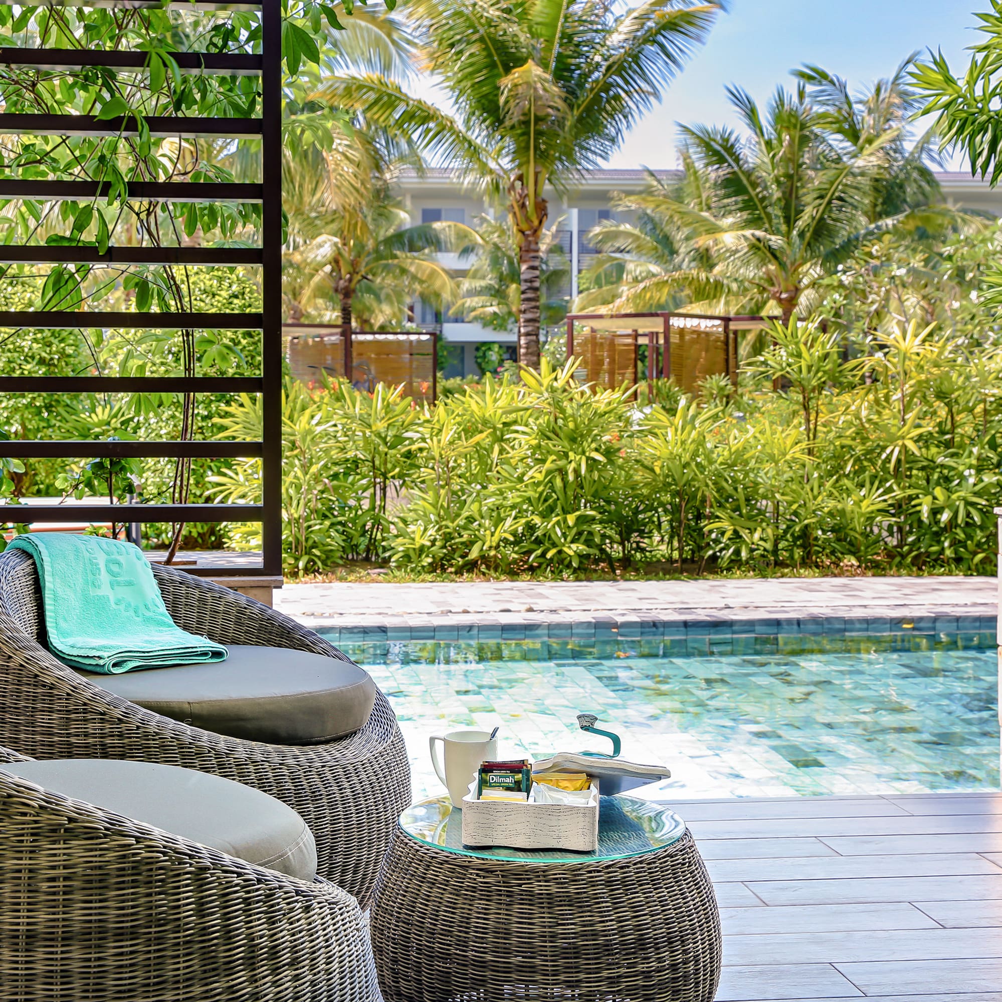a chair and table next to a pool