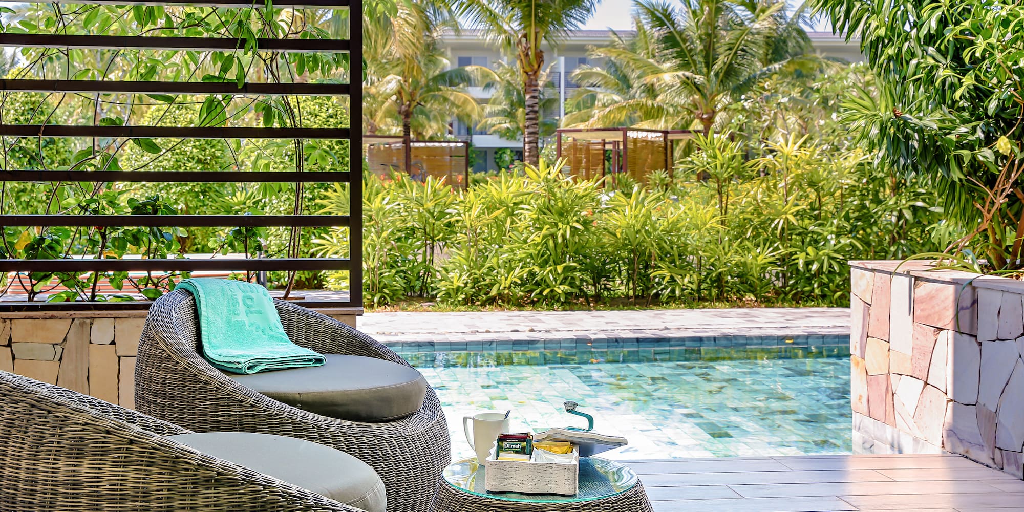 a chair and table next to a pool