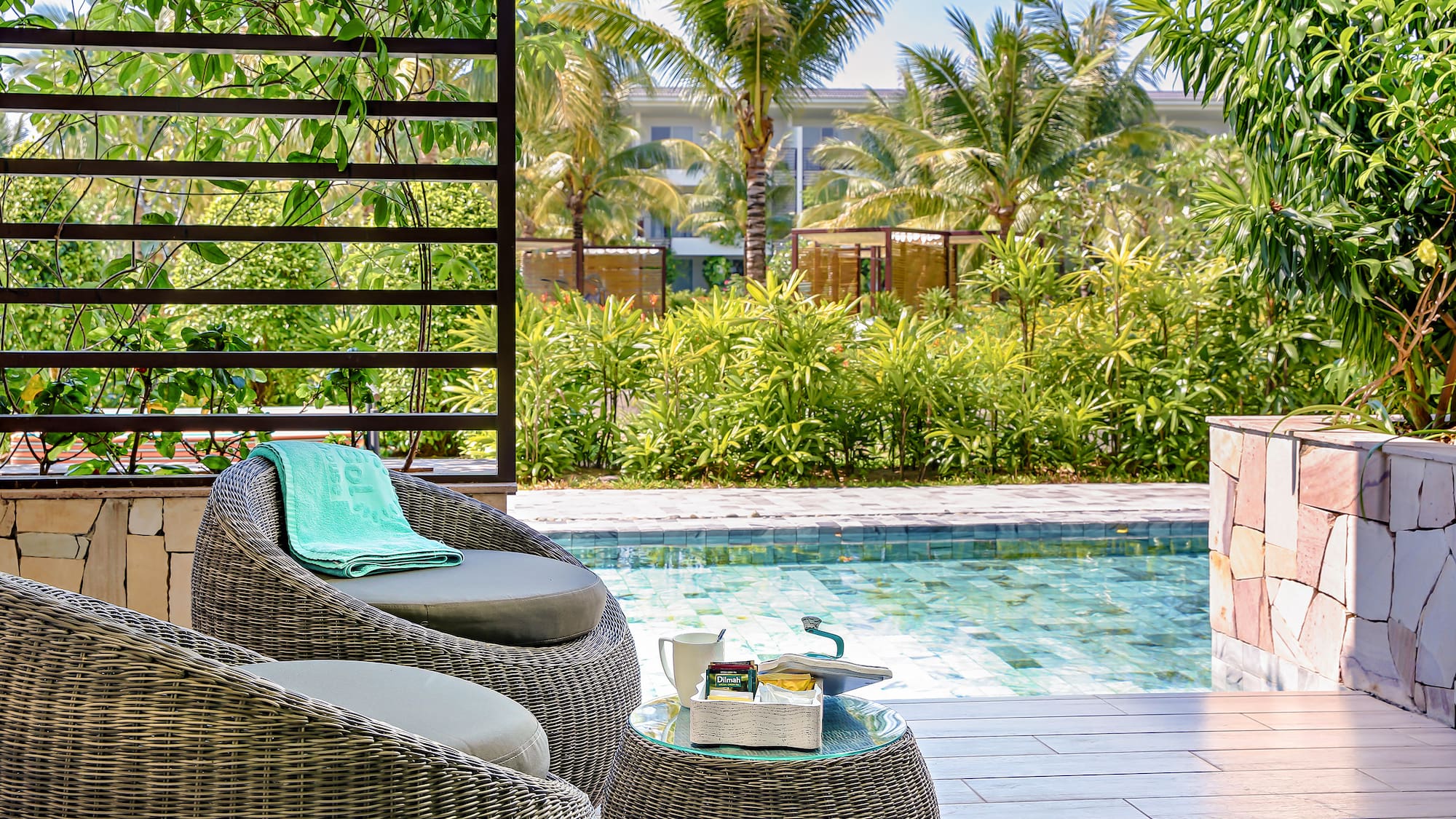 a chair and table next to a pool