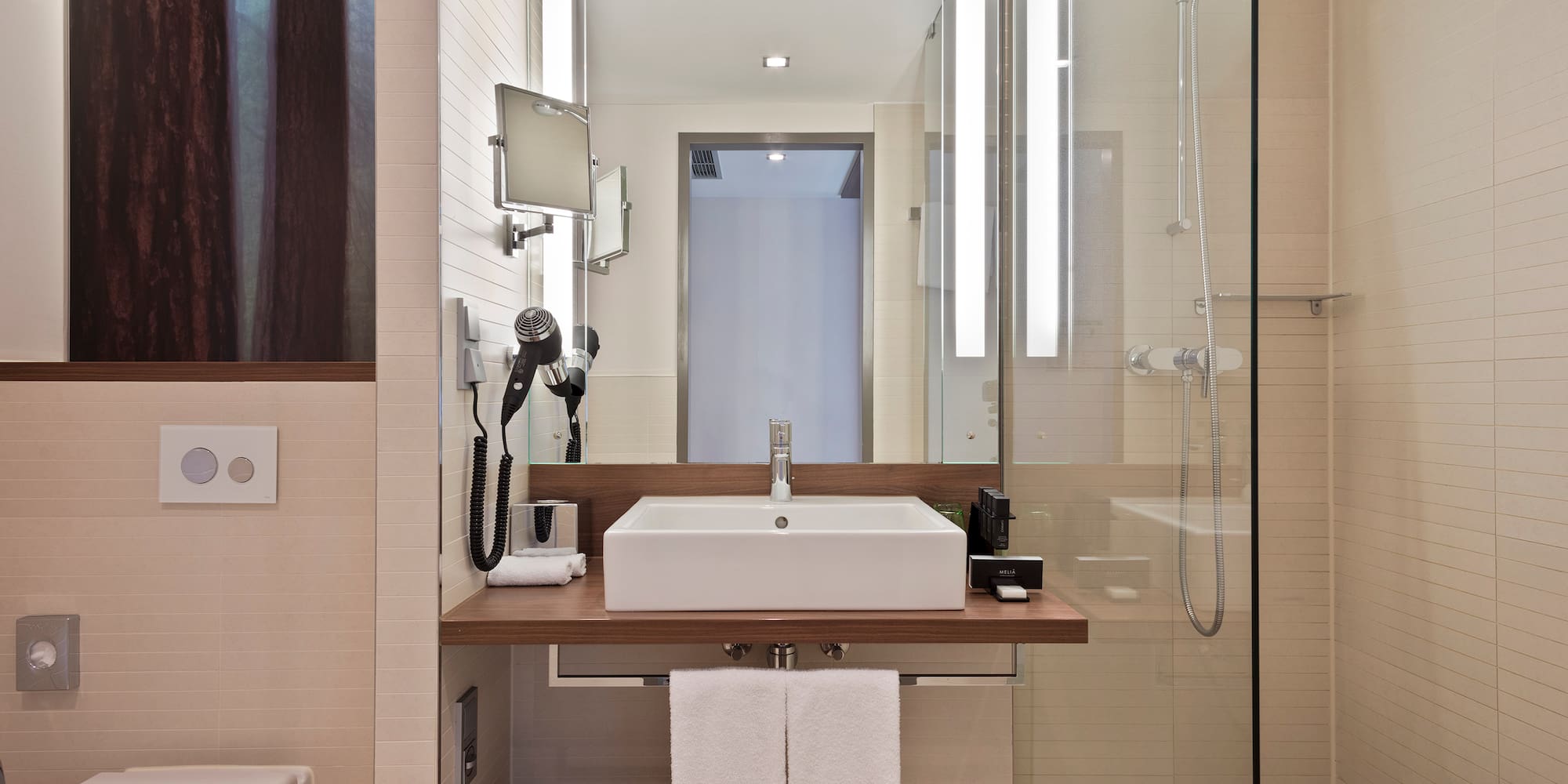 a bathroom with a glass shower and sink