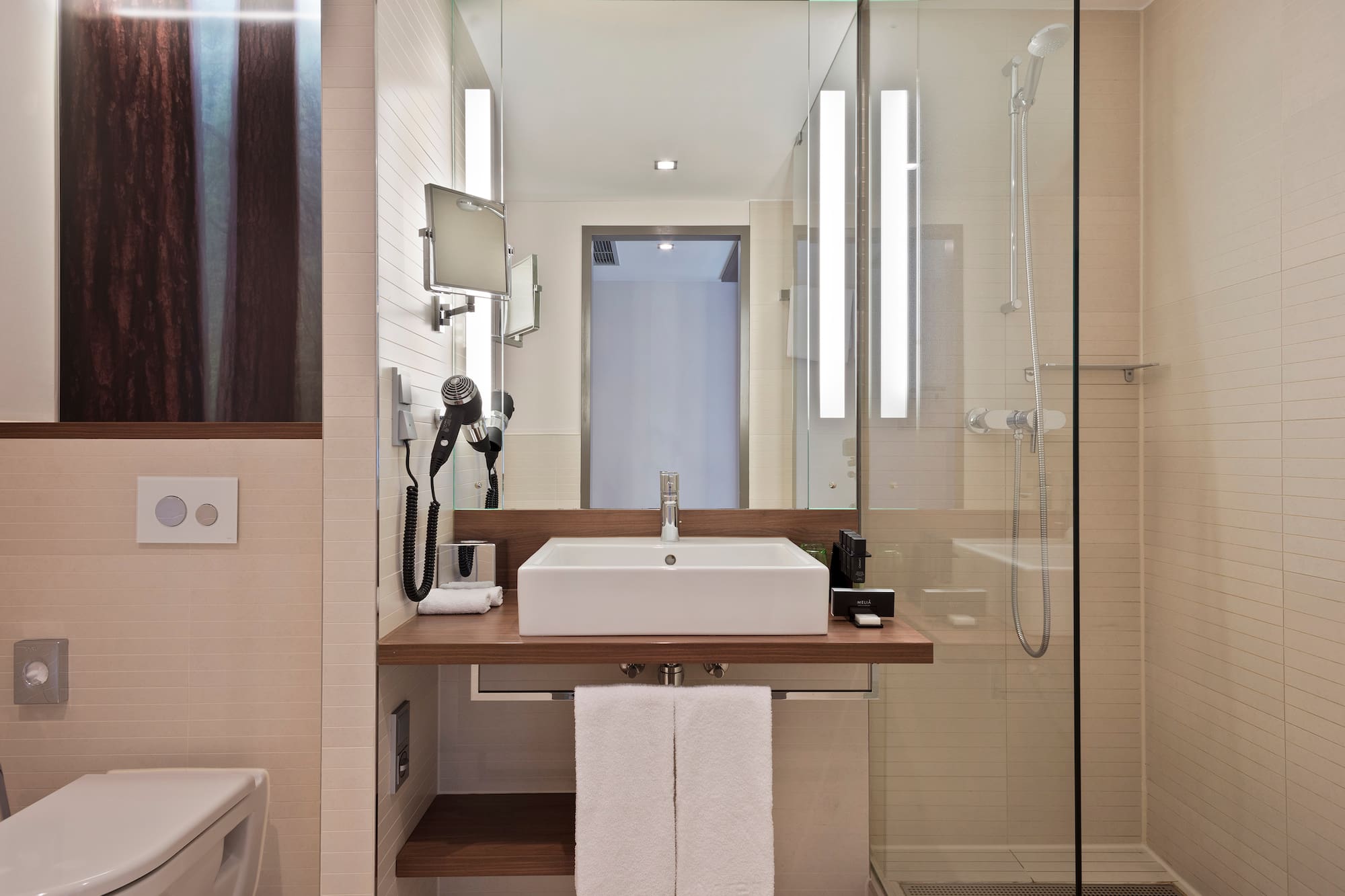 a bathroom with a glass shower and sink