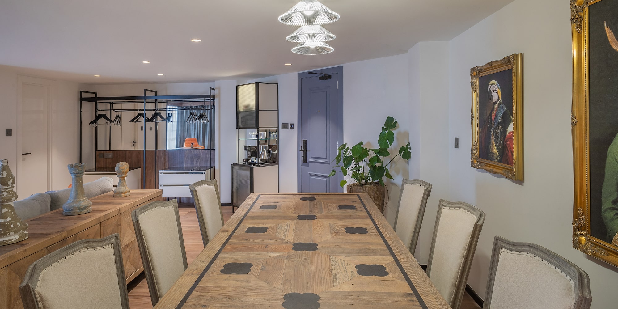 a room with a large table and chairs