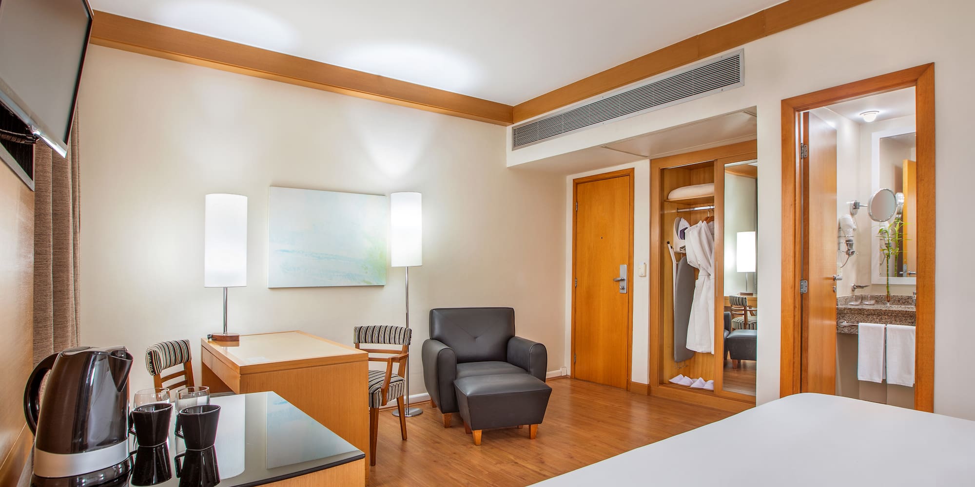 a room with a bed and a chair and a table