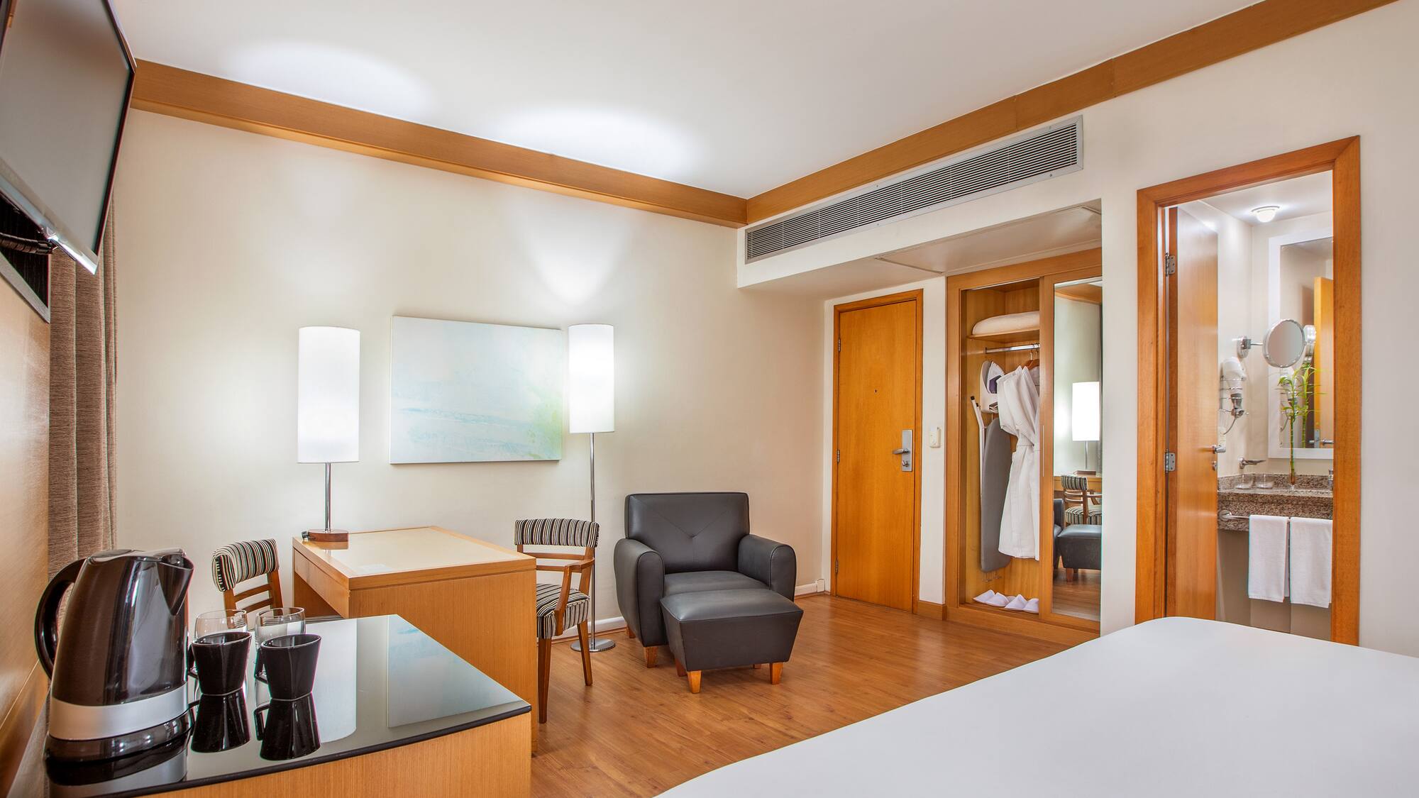 a room with a bed and a chair and a table