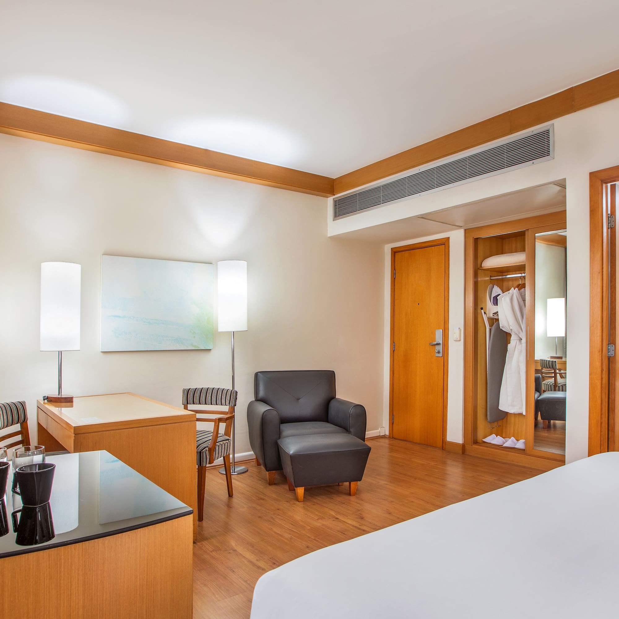 a room with a bed and a chair and a table