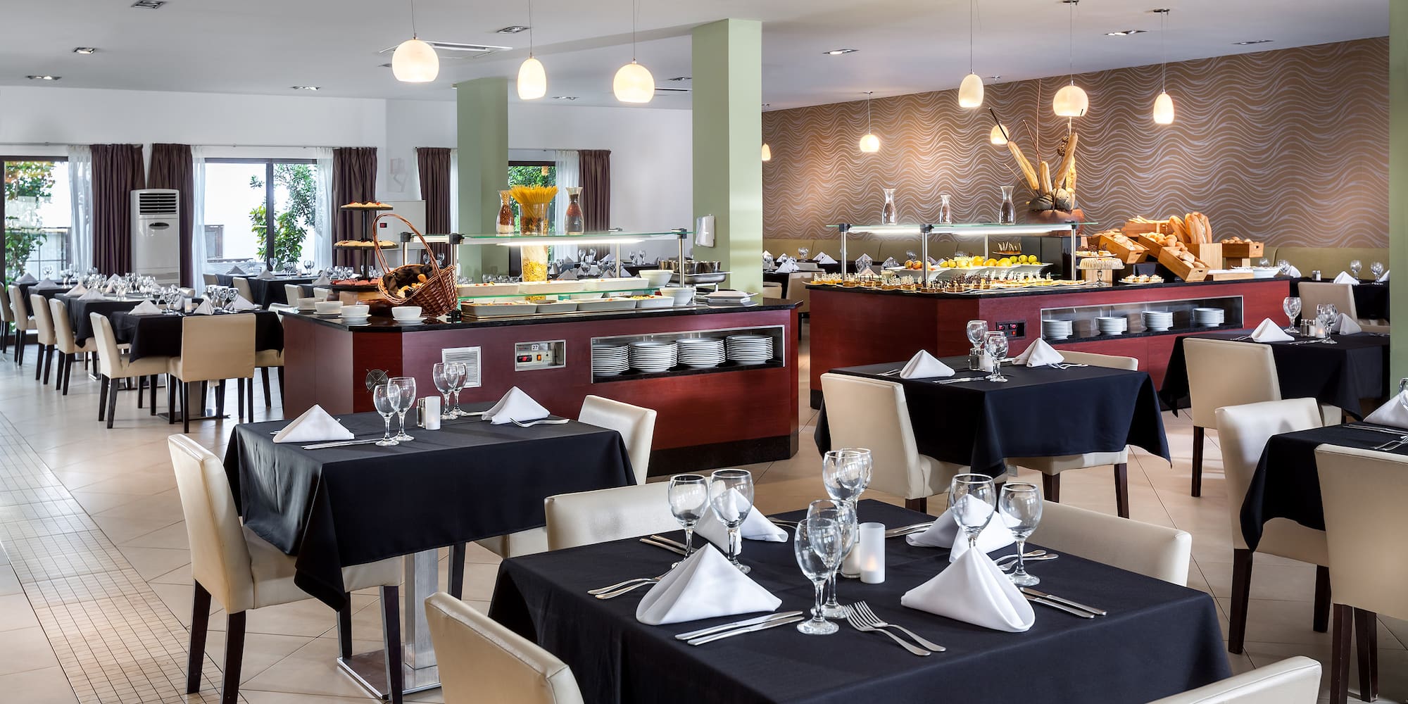 a restaurant with black tablecloths and white chairs
