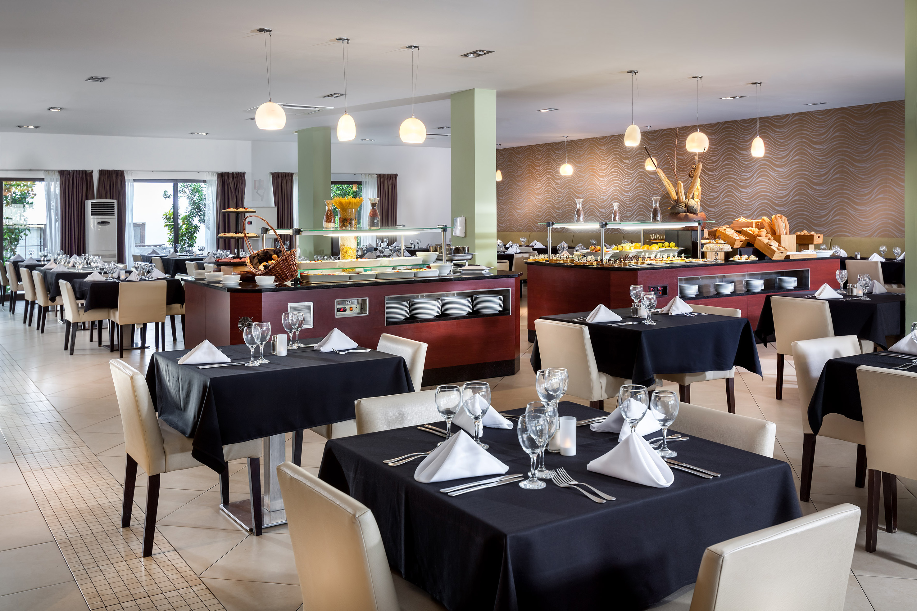 a restaurant with black tablecloths and white chairs