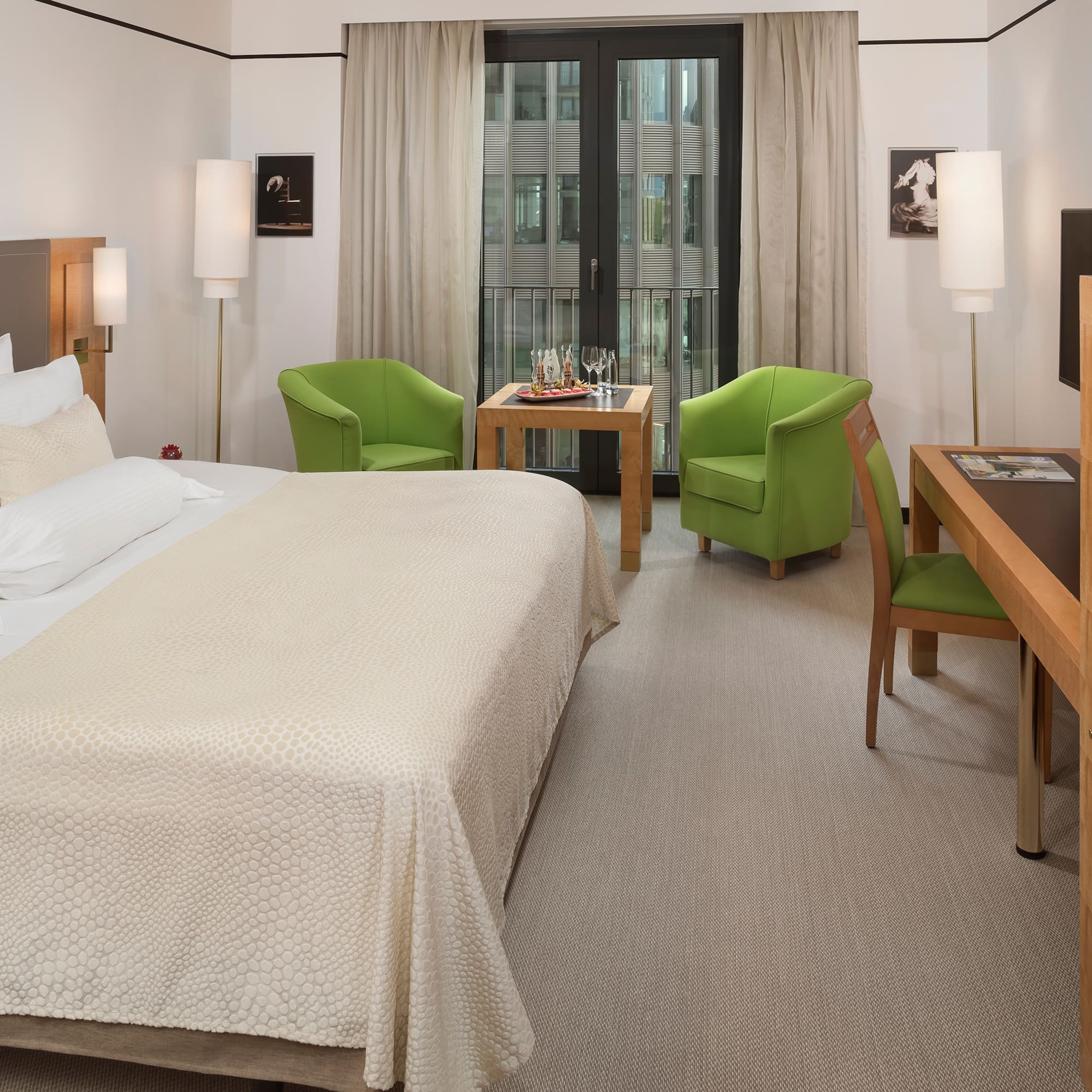 a room with a bed and a table and chairs