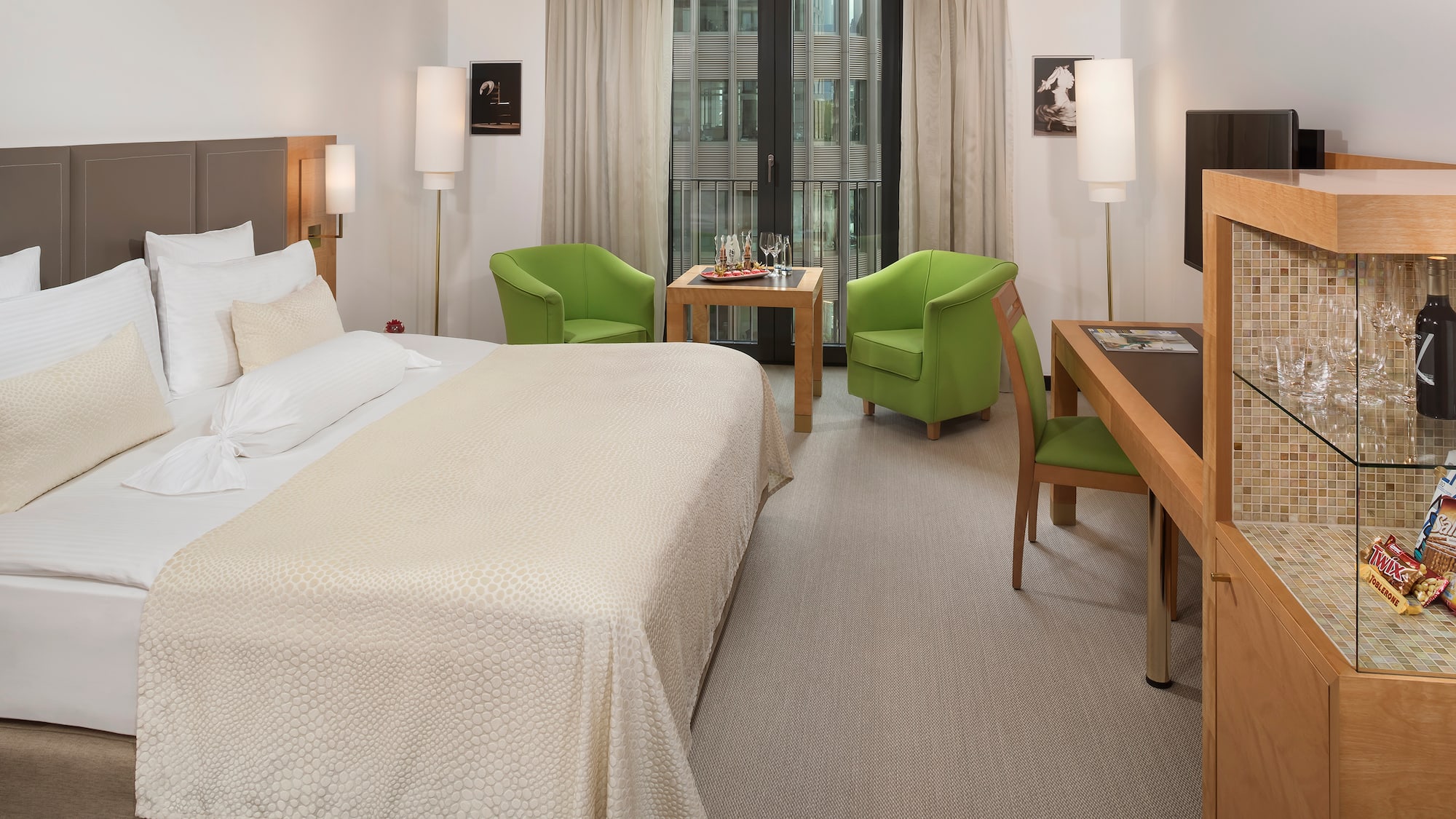 a room with a bed and a table and chairs