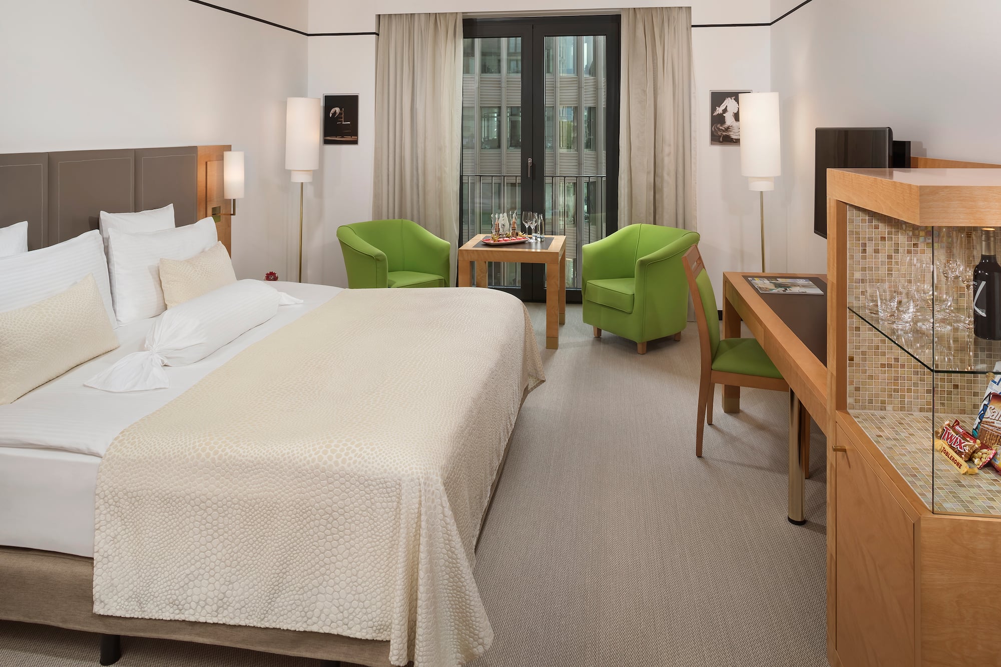 a room with a bed and a table and chairs