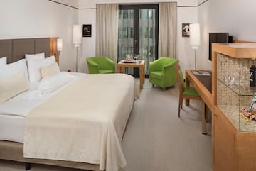 a room with a bed and a table and chairs