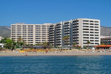 a large building with many windows and a beach