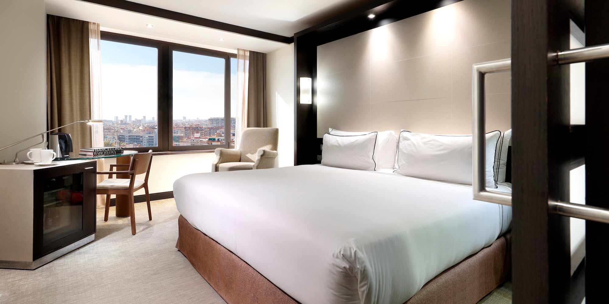 a room with a bed and chairs and a table