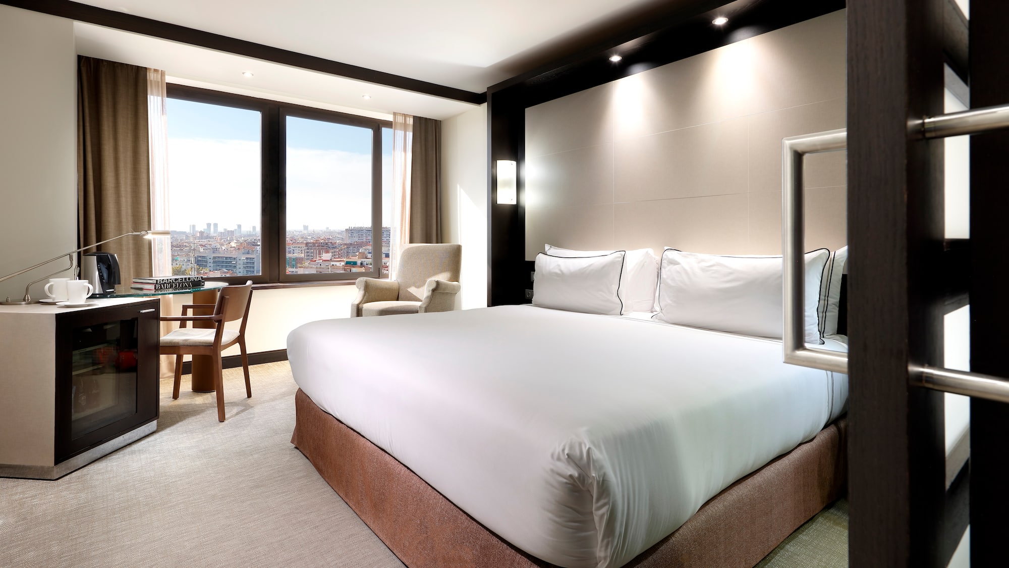 a room with a bed and chairs and a table