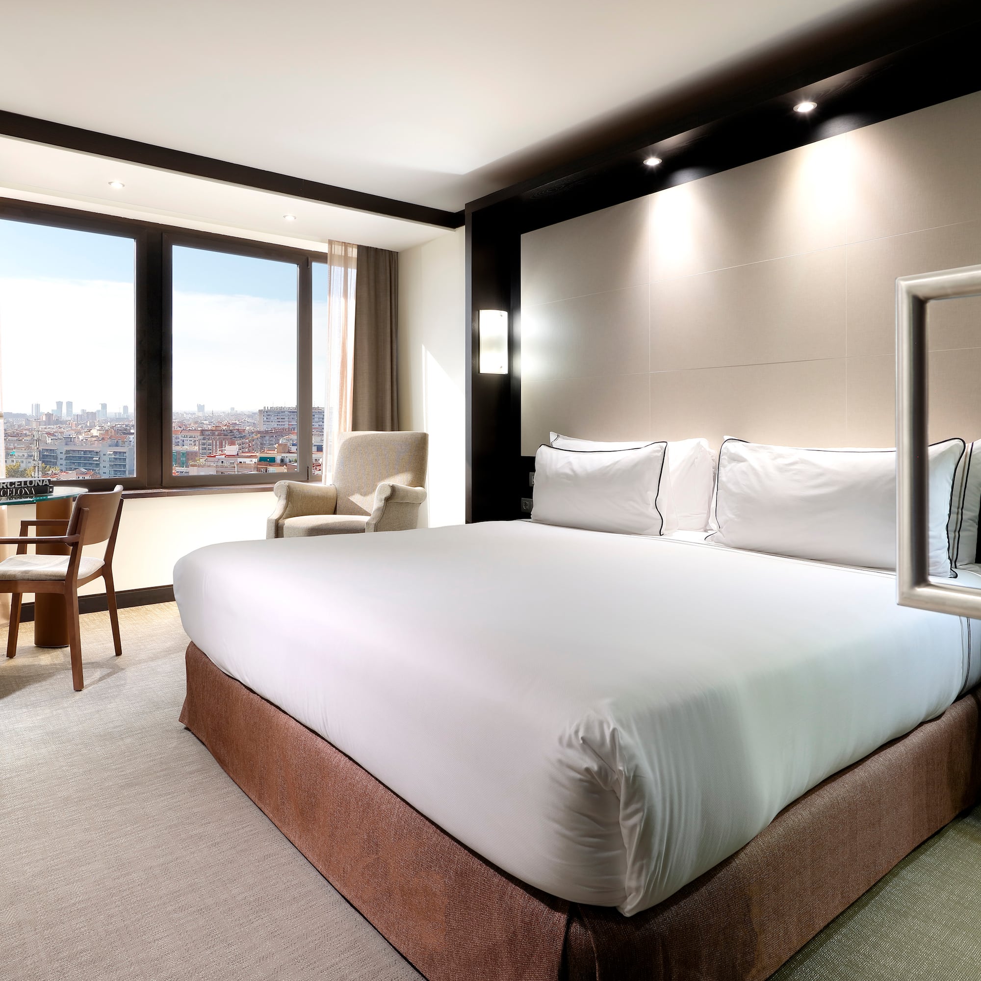 a room with a bed and chairs and a table