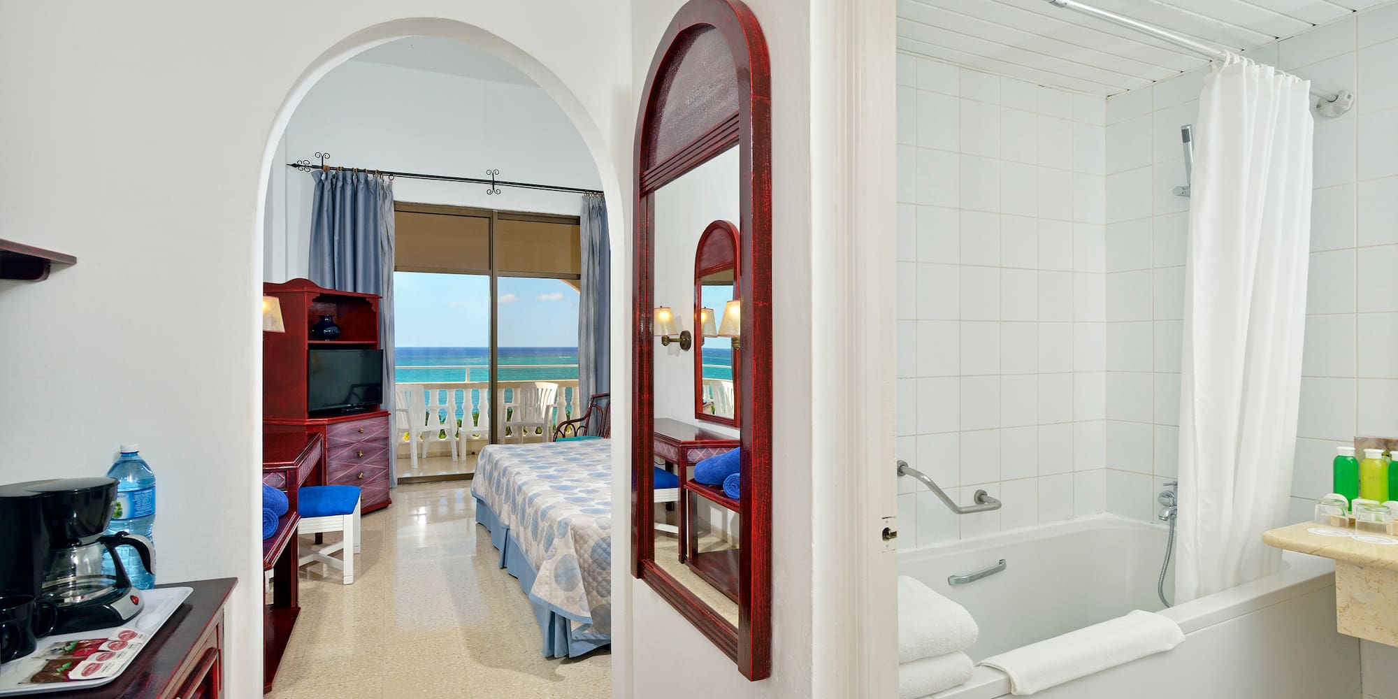 a bathroom with a bathtub and a bed