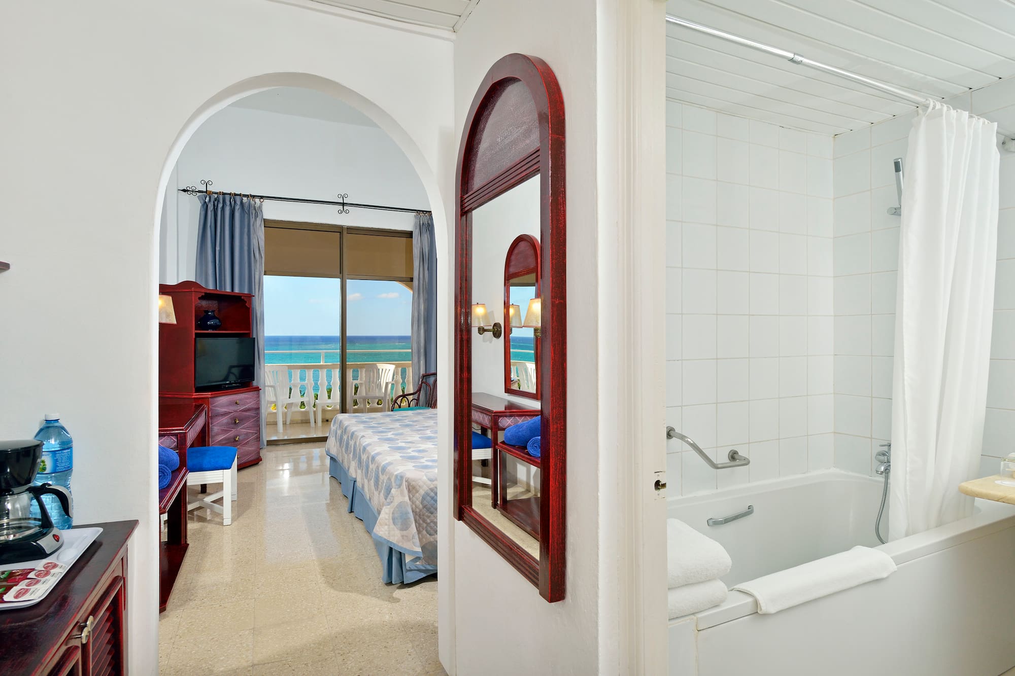 a bathroom with a bathtub and a bed