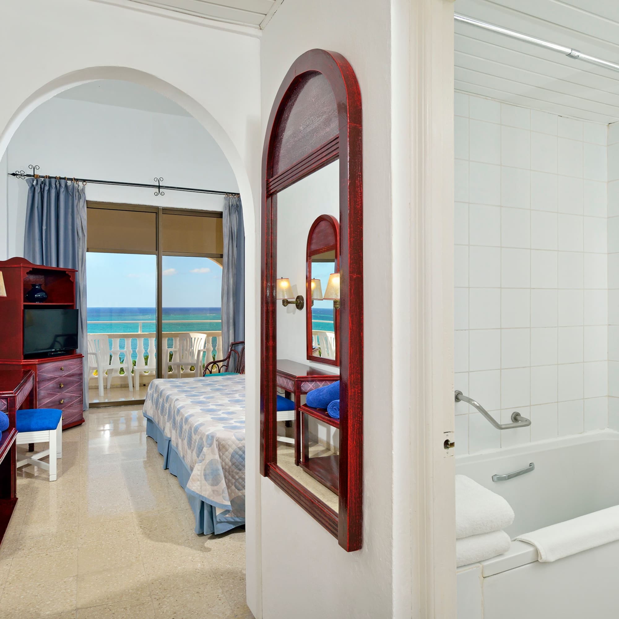 a bathroom with a bathtub and a bed