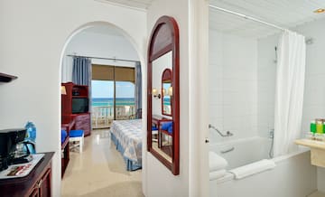 a bathroom with a bathtub and a bed