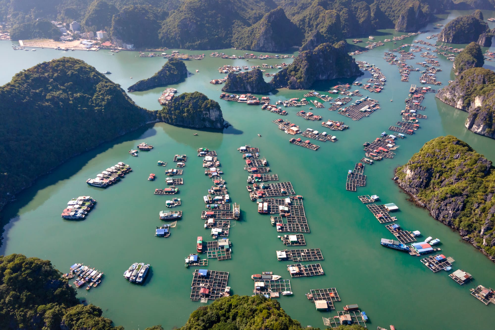 a aerial view of a body of water with boats and islands