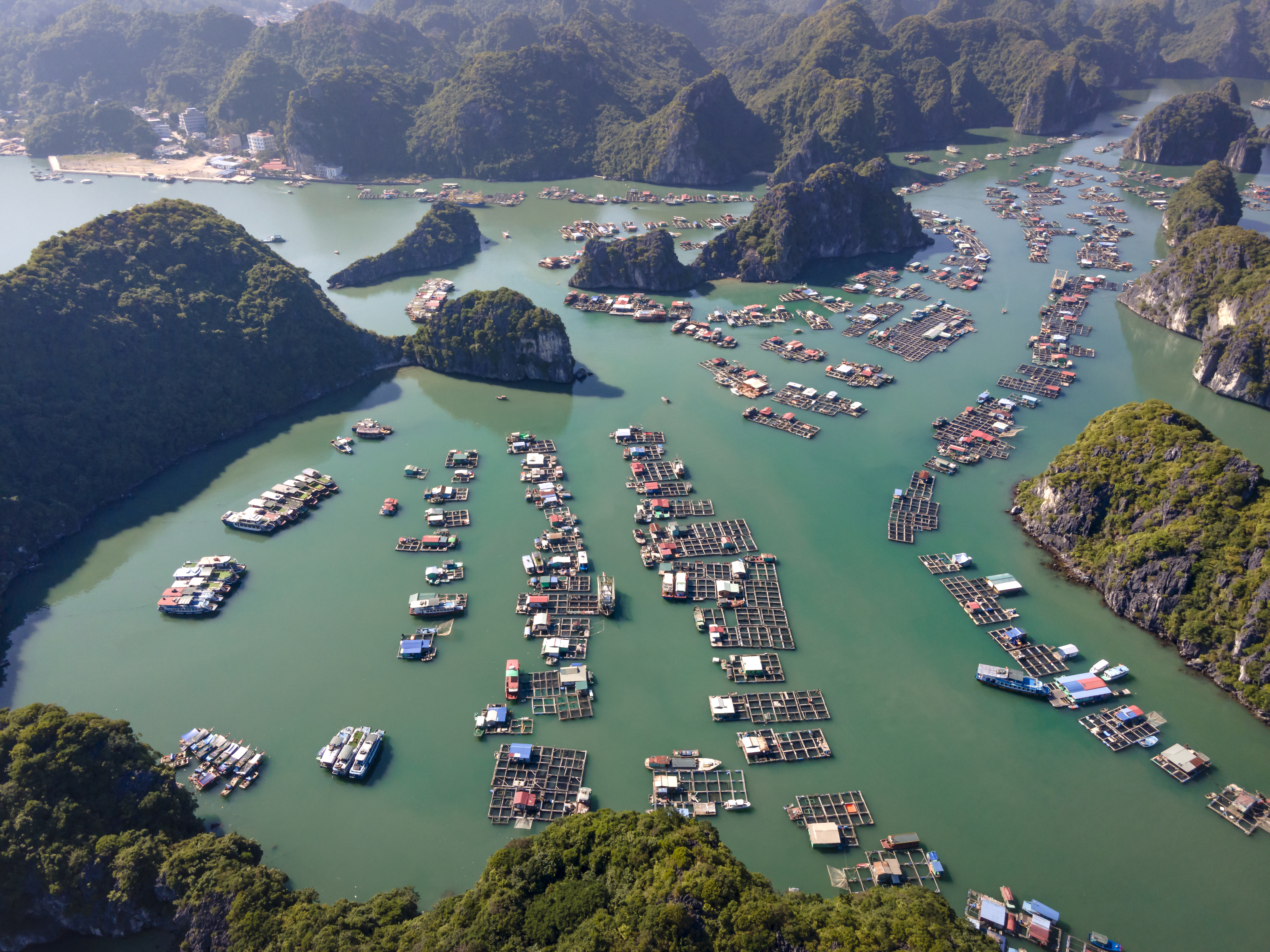 a aerial view of a body of water with boats and islands