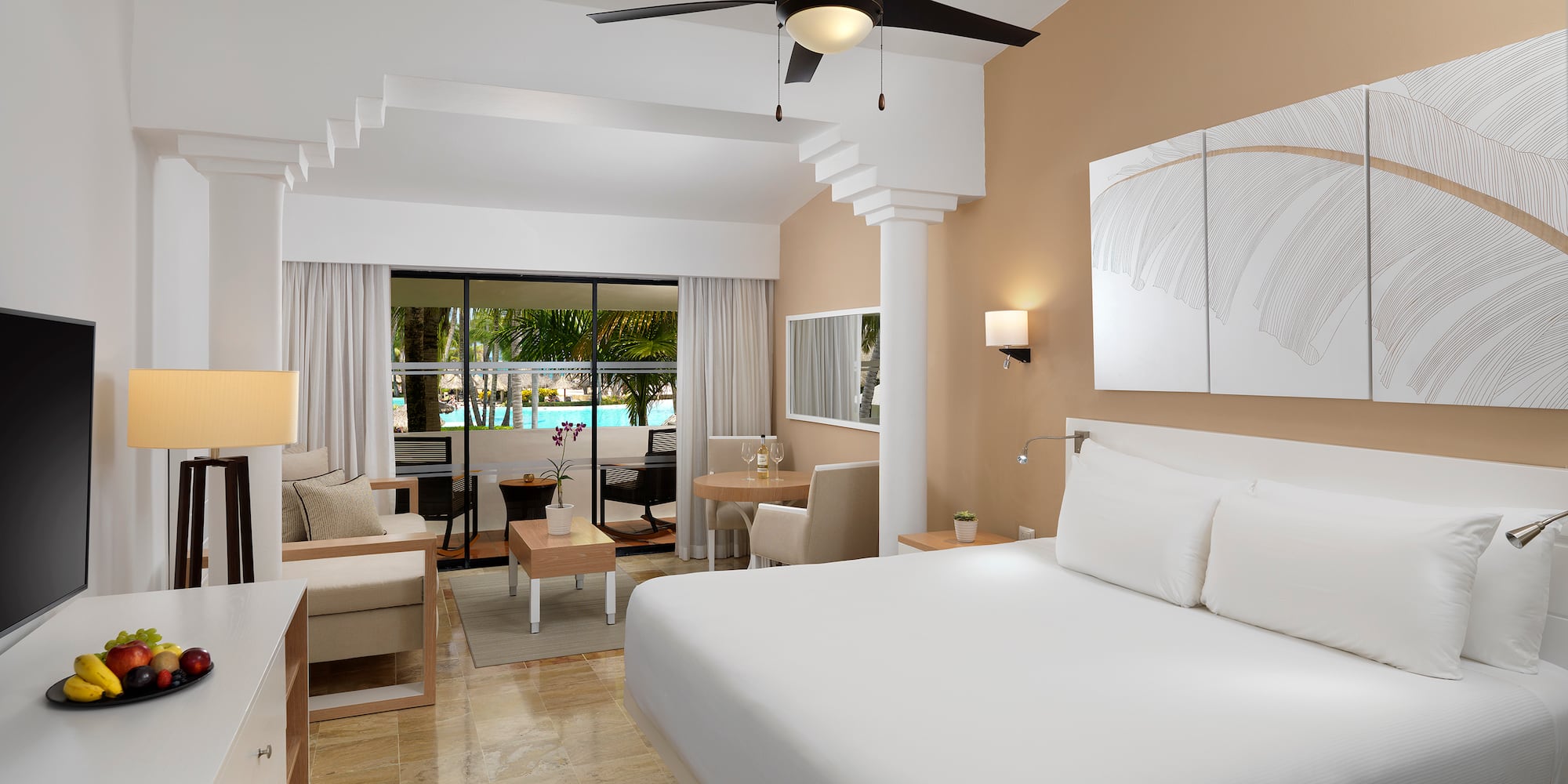 a room with a bed and a ceiling fan