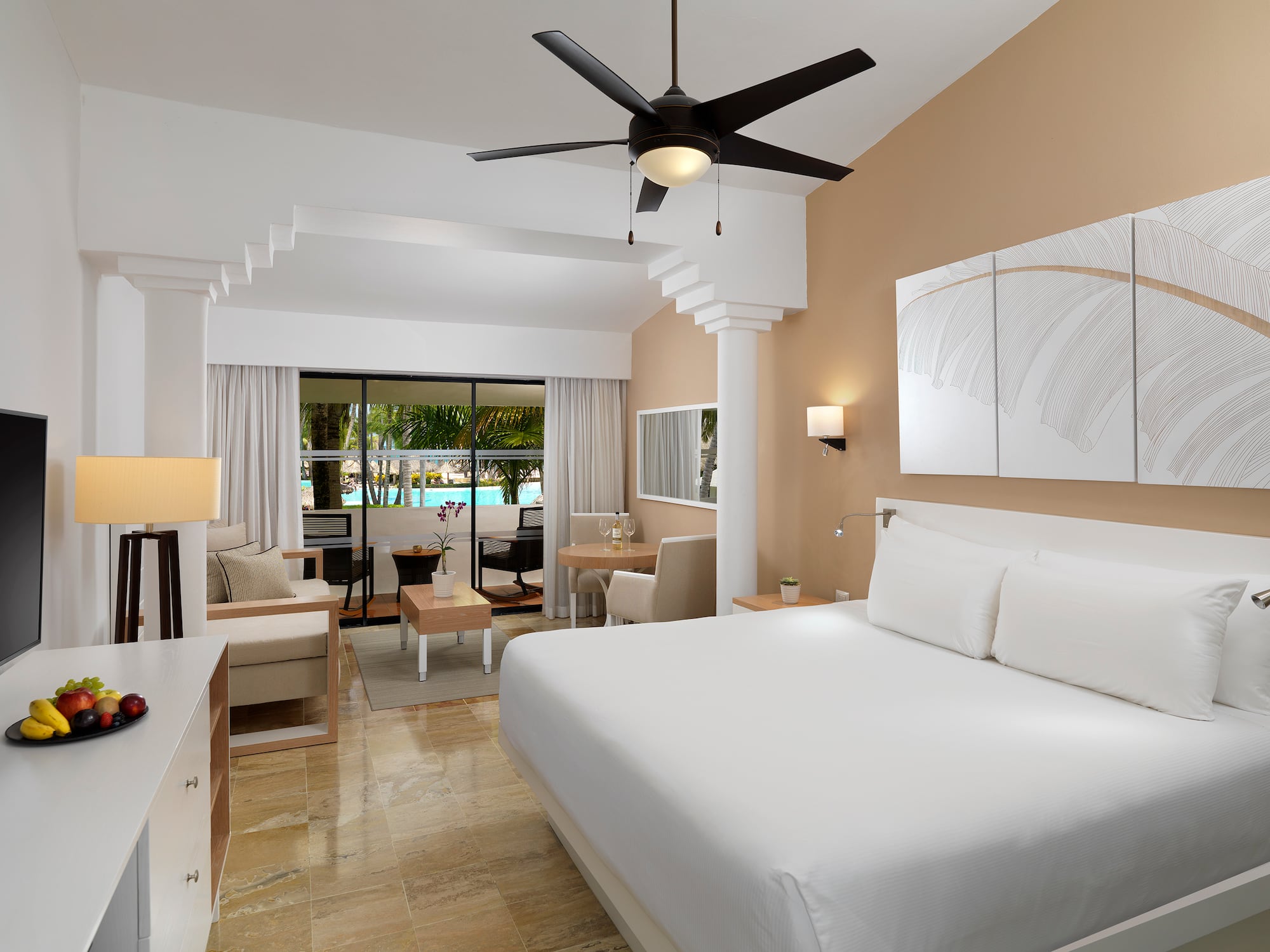 a room with a bed and a ceiling fan
