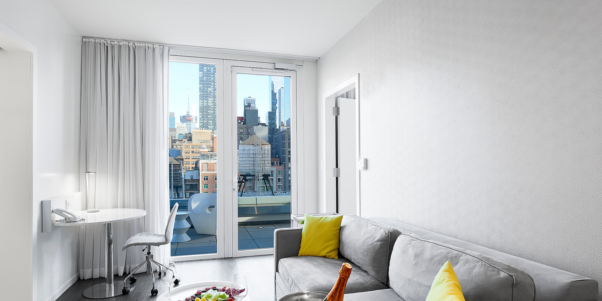 a room with a couch and a table and a glass door