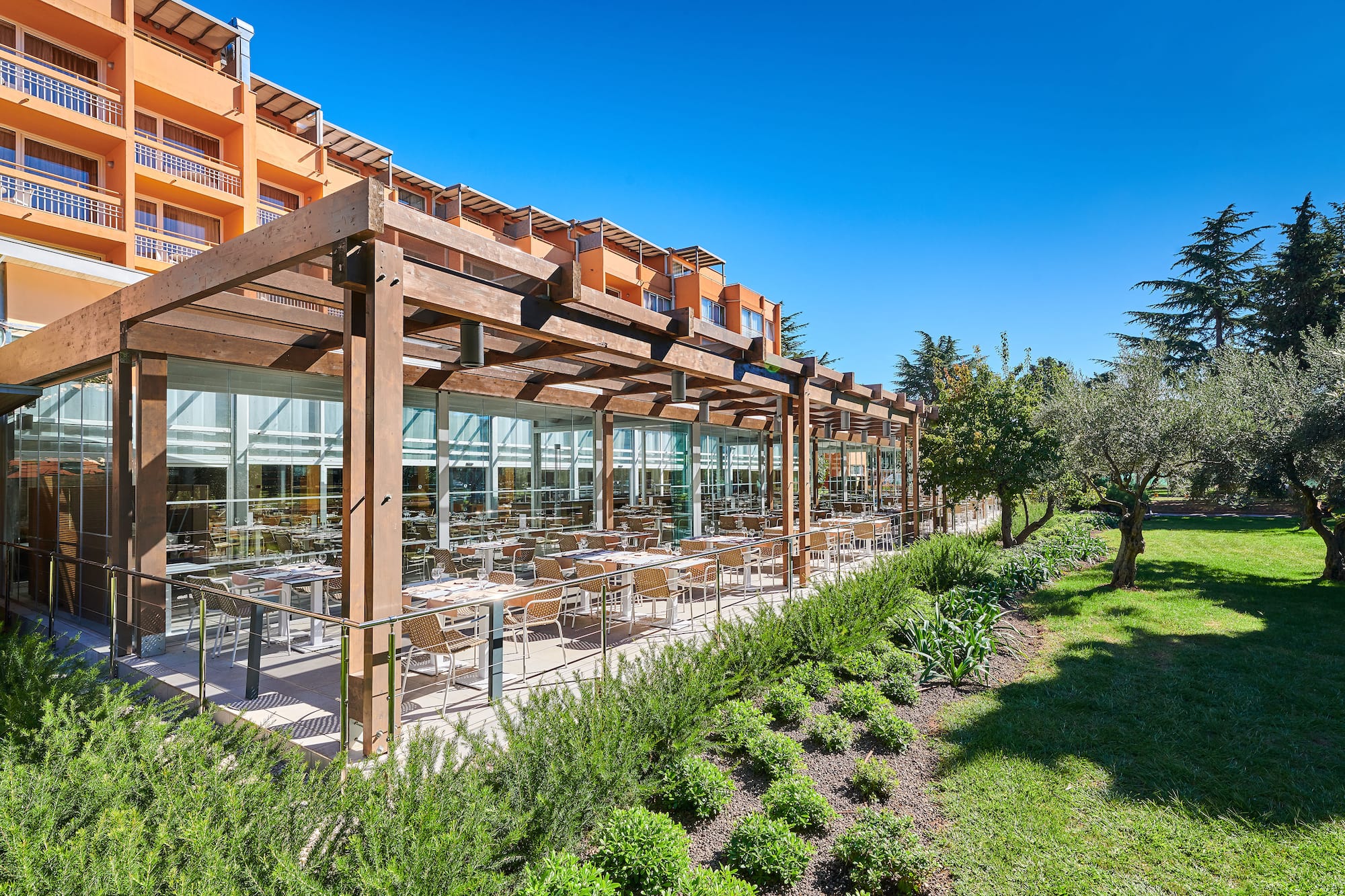 a building with a glass roof and tables outside