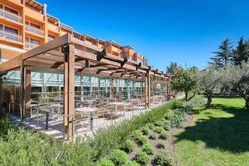 a building with a glass roof and tables outside