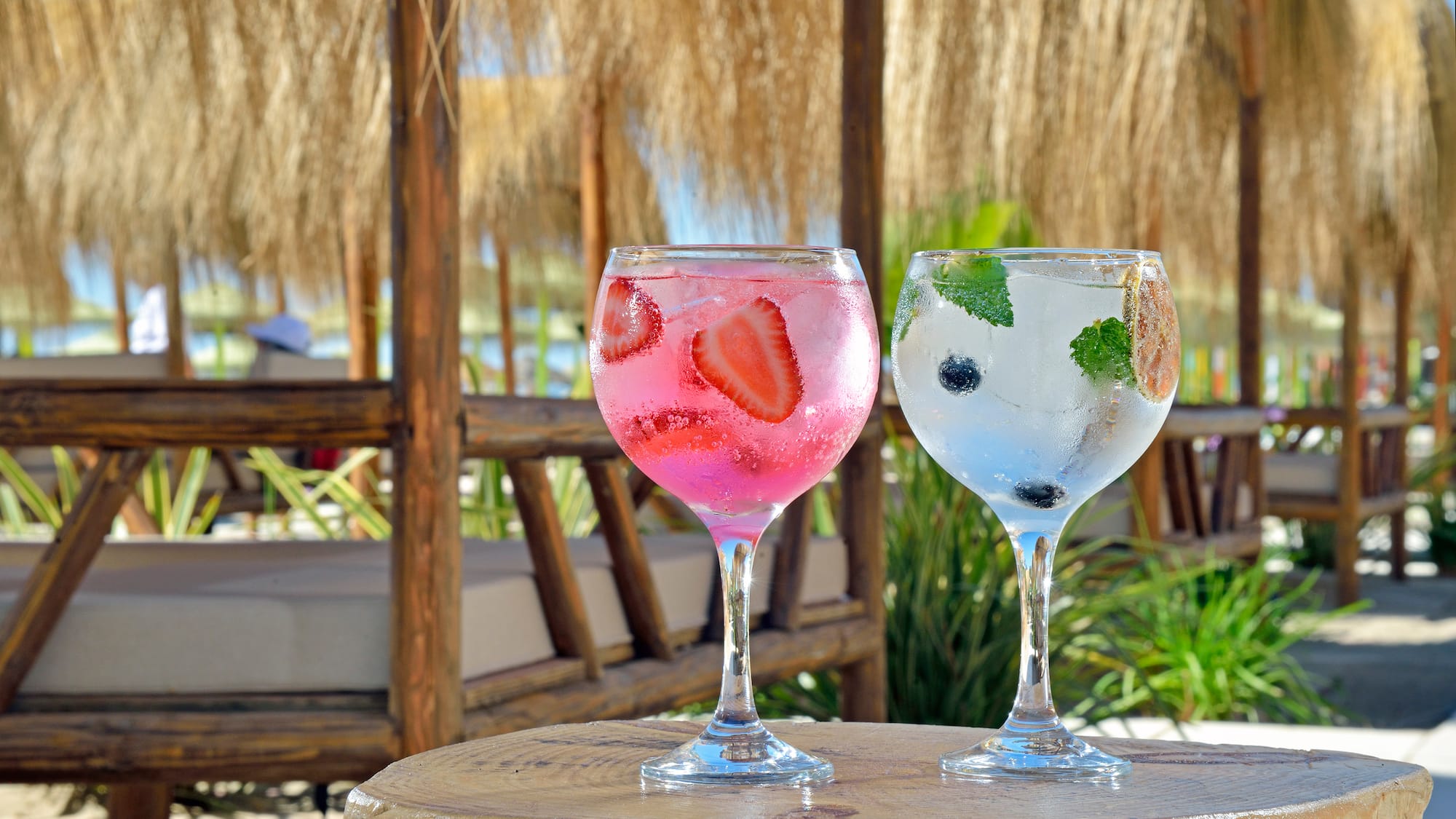 two glasses of drinks on a table