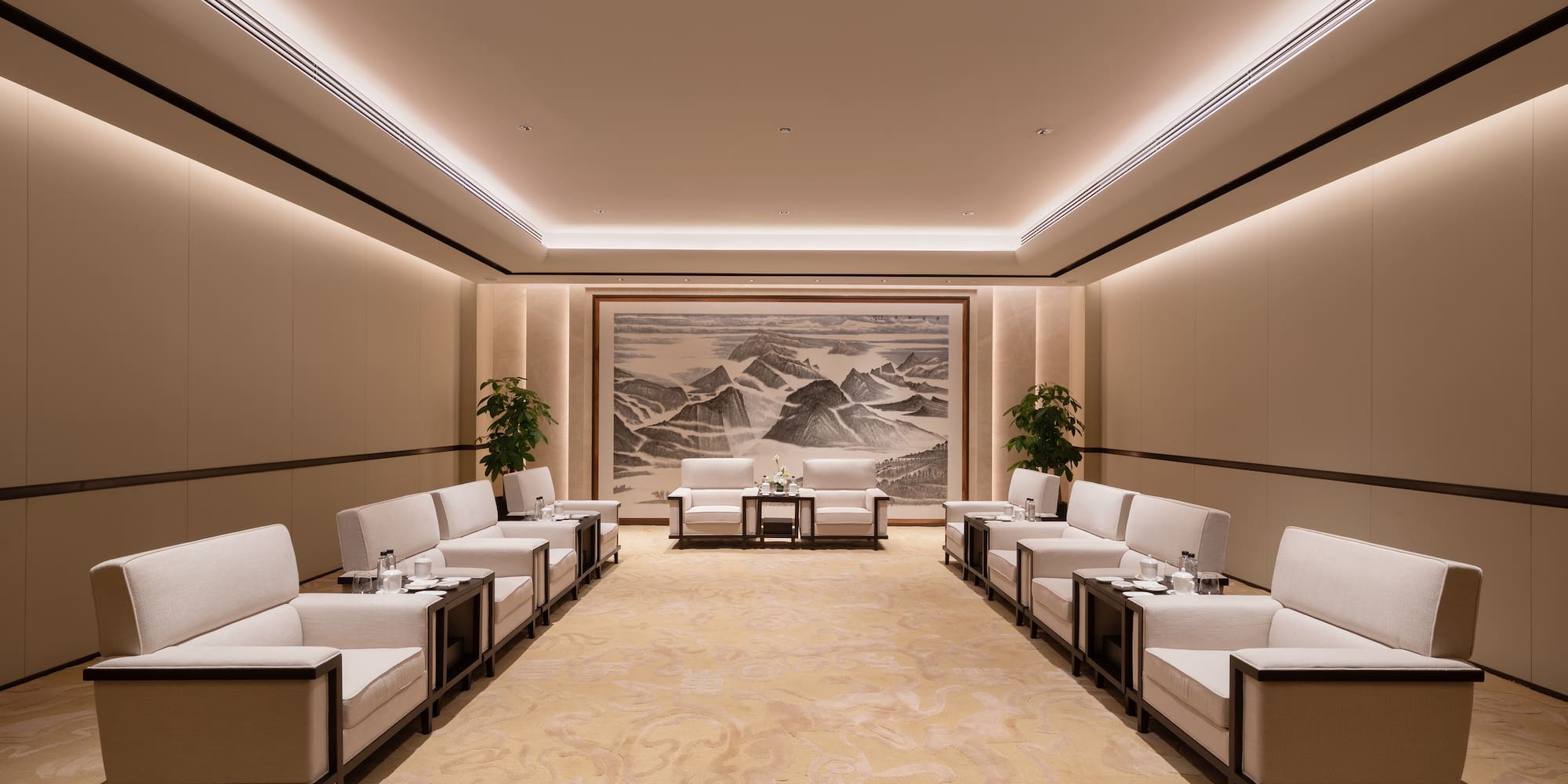 a room with white chairs and a painting on the wall