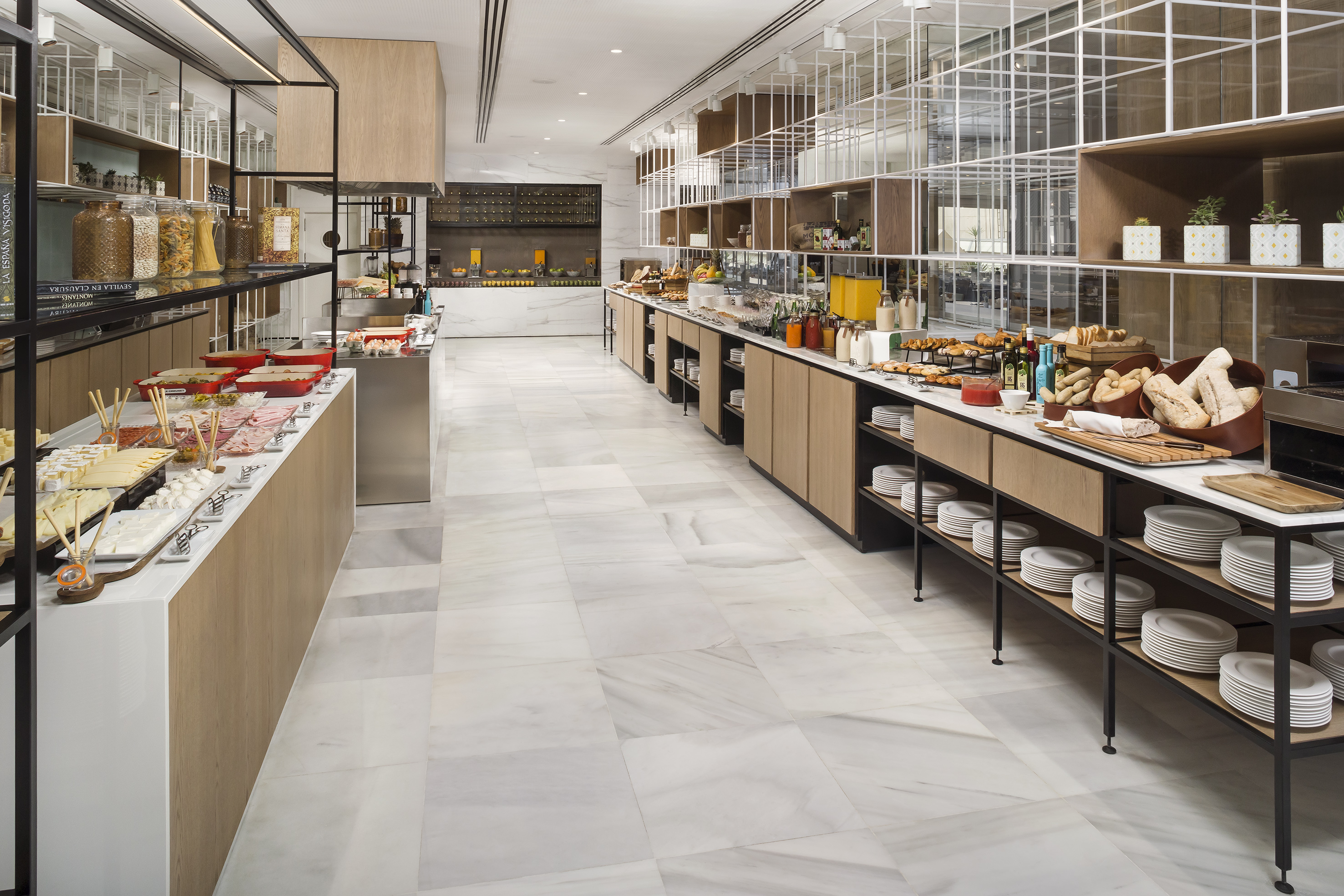 Modern hotel breakfast buffet with fresh food, pastries, and juices.