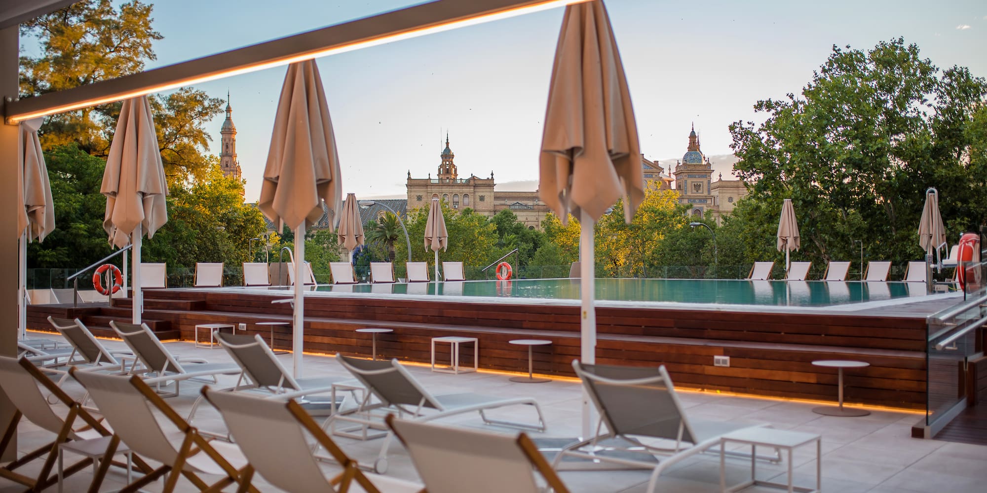 a pool with chairs and umbrellas