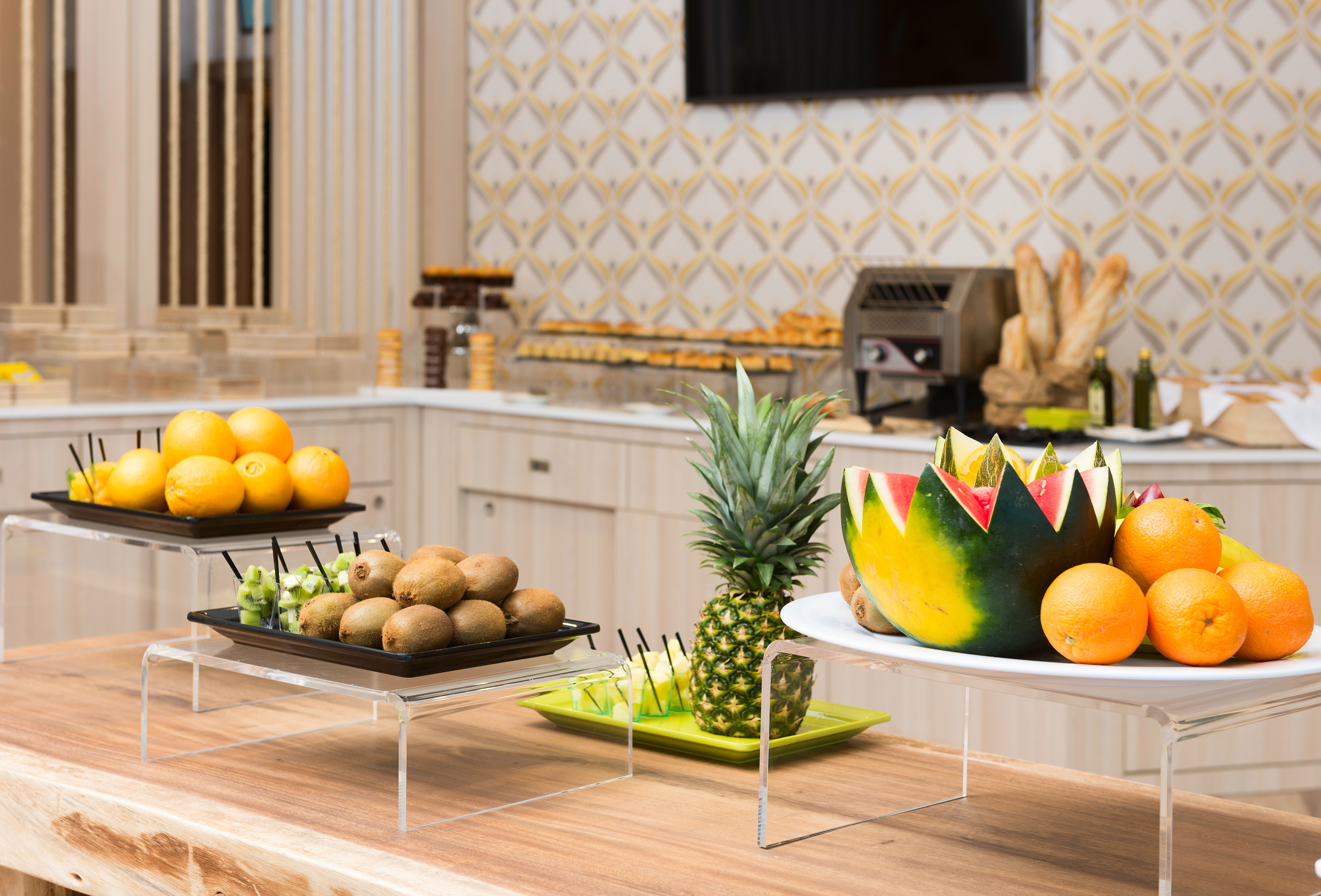 Hotel buffet with fresh tropical fruits: watermelon, pineapple, oranges, kiwi.