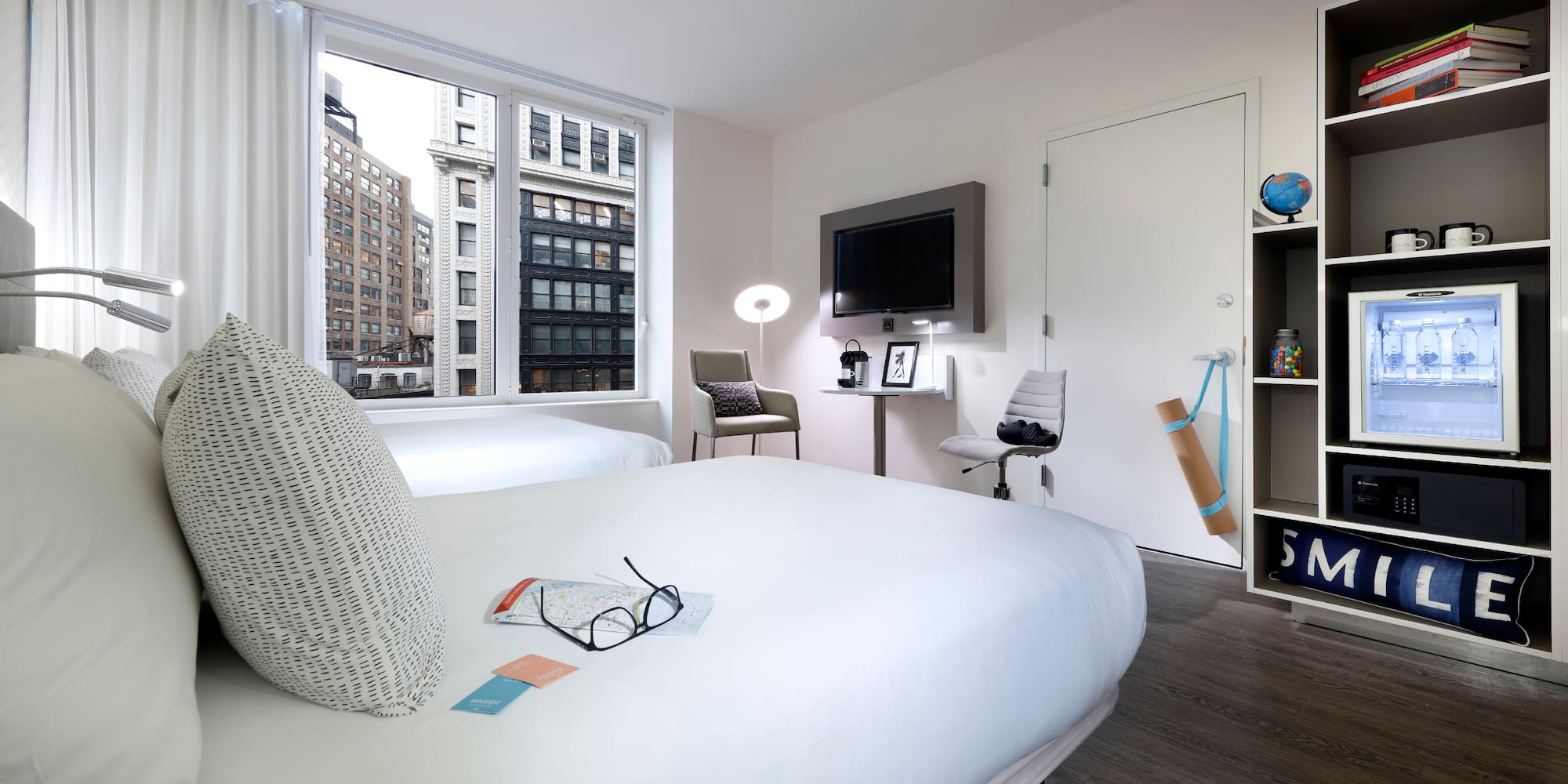 a room with two beds and a tv