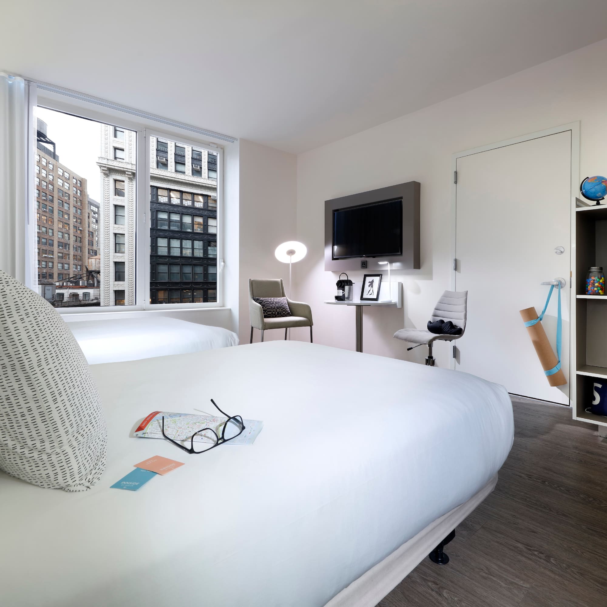 a room with two beds and a tv