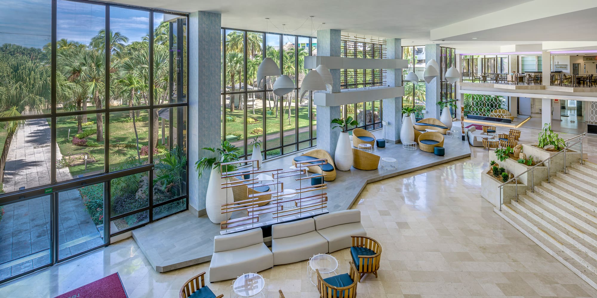 a large room with a large window and a large area with tables and chairs