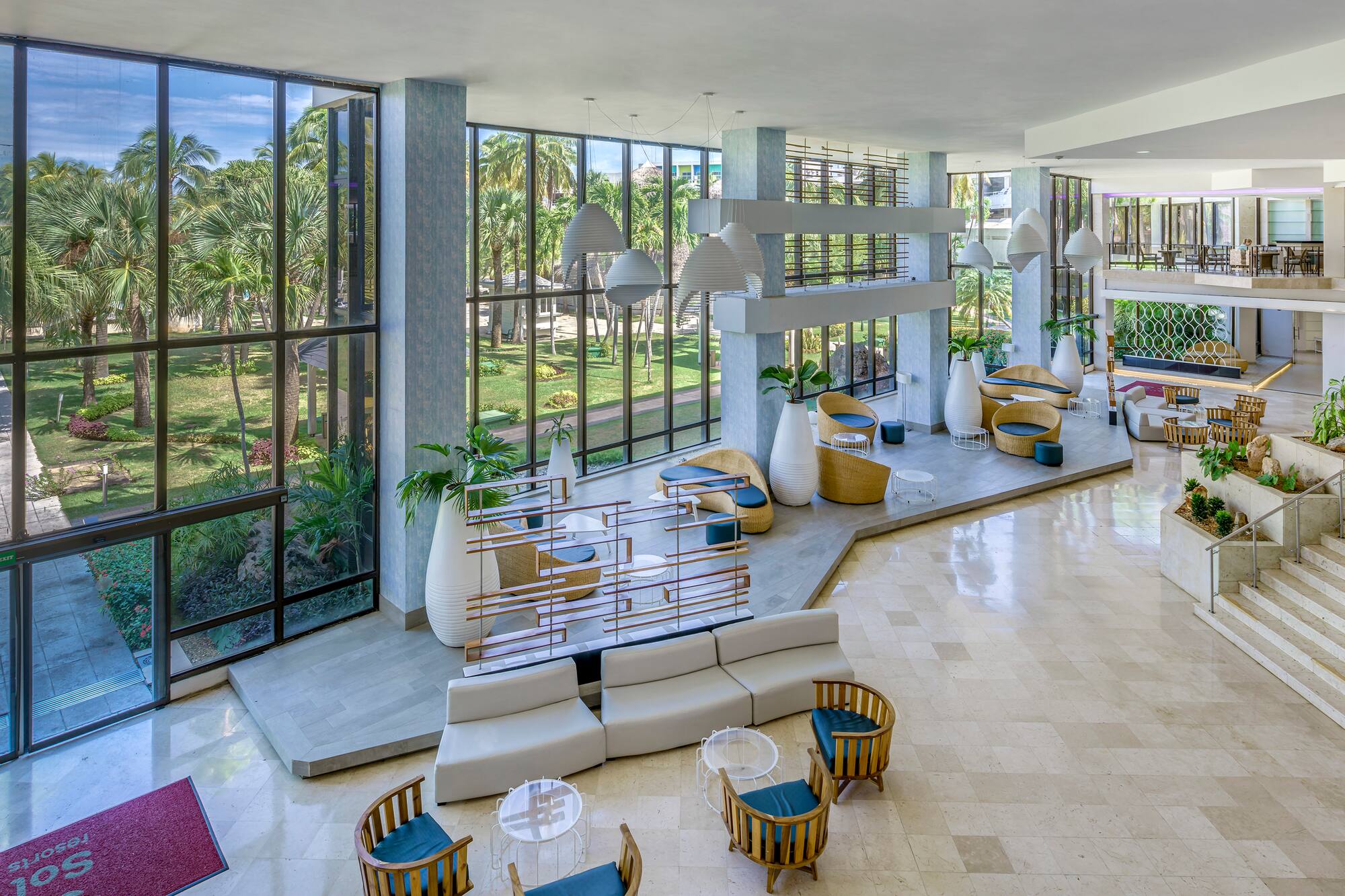 a large room with a large window and a large area with tables and chairs