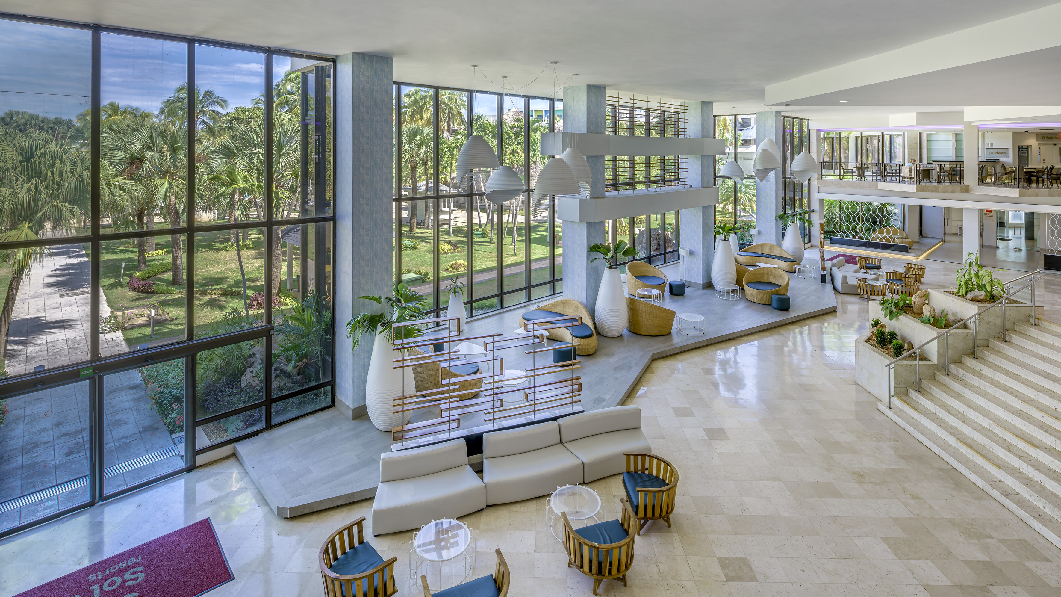 a large room with a large window and a large area with tables and chairs