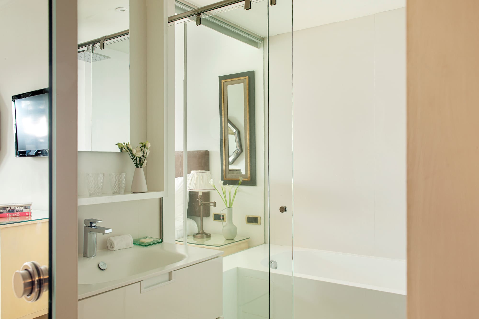 a bathroom with a glass shower door