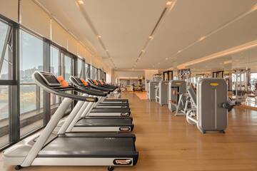 a large room with treadmills and exercise equipment