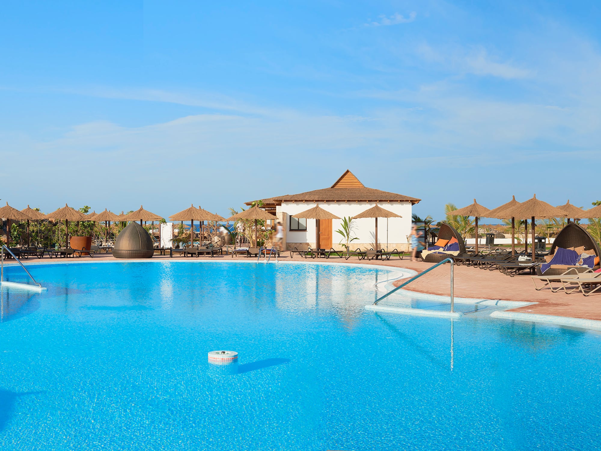 a pool with umbrellas and chairs