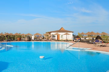 a pool with umbrellas and chairs