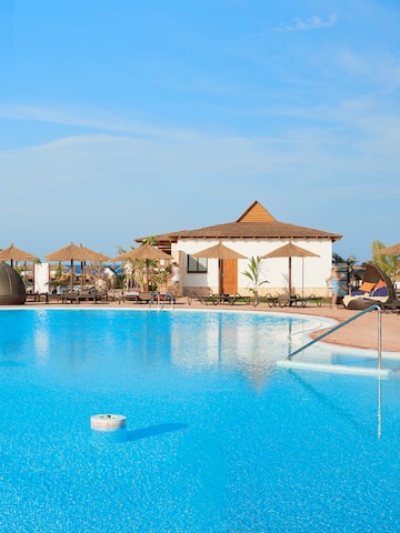 a pool with umbrellas and chairs