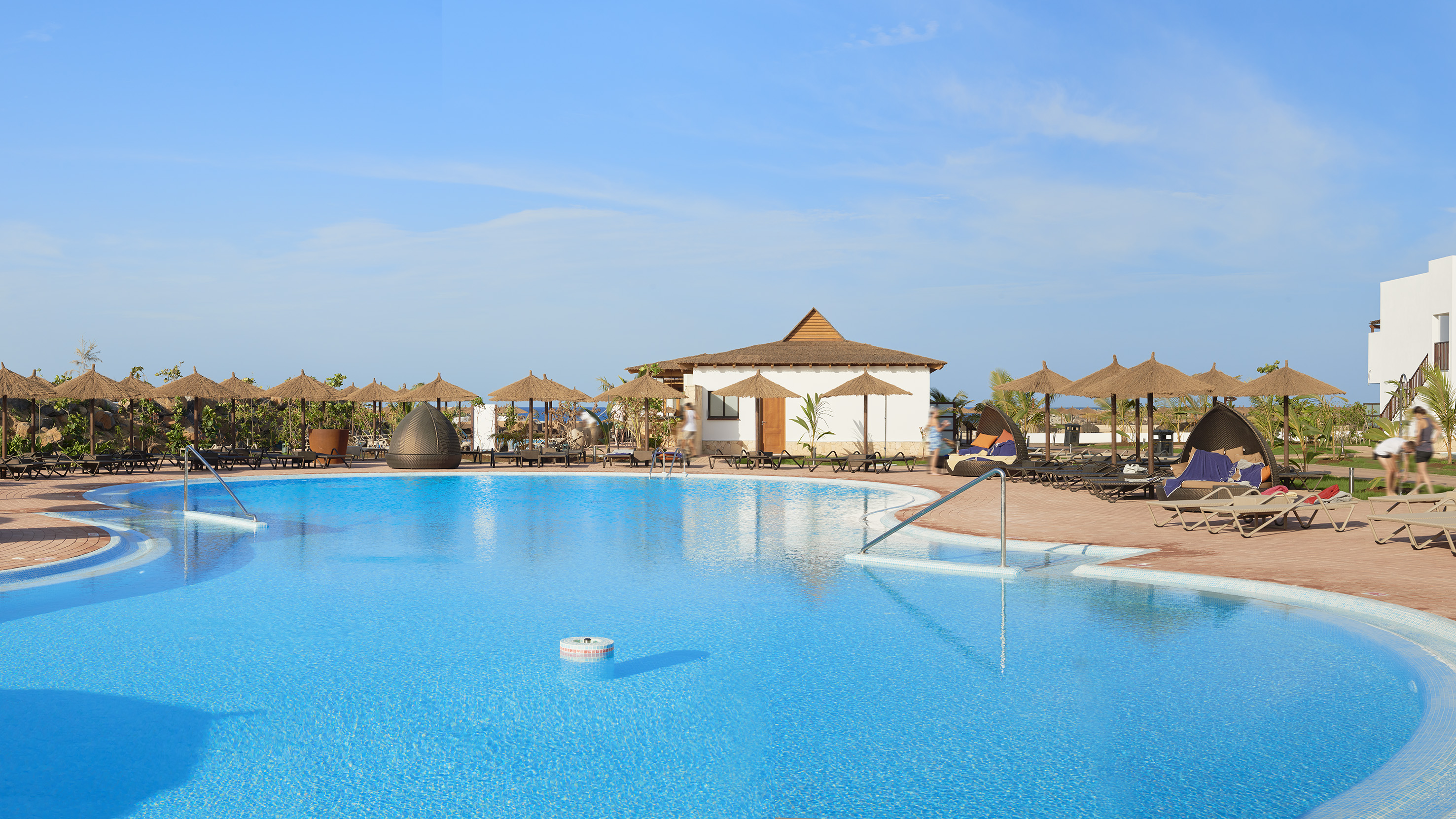 a pool with umbrellas and chairs