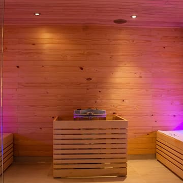 a wooden sauna with a purple light