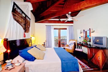 a bedroom with a bed and a table and chairs